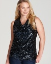 Dripping with dazzle, this sequin Calvin Klein Plus top illuminates your 9-to-5 look beneath a crisp blazer, then shines on its own after hours.