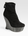 Lifted by a statuesque, architectural wooden wedge, this stretch suede ankle boot has an exposed back zipper and wooden platform. Wooden wedge, 5 (125mm)Wooden platform, 1½ (40mm)Compares to a 3½ heel (90mm)Stretch suede upperBack zipperLeather lining and solePadded insoleImportedOUR FIT MODEL RECOMMENDS ordering one size up as this style runs small. 