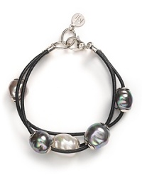 A triple strand leather bracelet accented with floating pearls from Majorica.