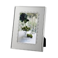 A scalloped border inspired by delicate lace lends classically feminine style to this silver-plated frame from Vera Wang. A scalloped border inspired by delicate lace lends classically feminine style to this silver-plated frame from Vera Wang.