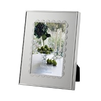 A scalloped border inspired by delicate lace lends classically feminine style to this silver-plated frame from Vera Wang.