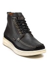A handsomely rugged boot from Paul Smith rendered with a moc toe, contrast stitching and chunky contrast rubber sole.