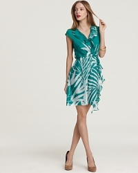 A palm-leaf print brings tropical chic while a cascading ruffle lends feminine flair to this Milly wrap dress of supple silk. A palm-leaf print brings tropical chic while a cascading ruffle lends feminine flair to this Milly wrap dress of supple silk.