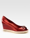 A signature horsebit detail adorns this logo-embossed metallic leather wedge with a classic peep toe and textured rope edging. Self-covered wedge with rope edging, 2¼Covered platform, ¾ (20mm)Compares to a 1½ heel (40mm)Metallic leather upperPeep toeLeather liningRubber solePadded insoleMade in Italy