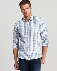 Furnished with front and back darts for a slim, modern fit, this smooth button-down cuts a cool figure wherever you choose to wear it. Furnished with front and back darts for a slim, modern fit, this smooth button-down cuts a cool figure wherever you choose to wear it.
