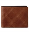 Fossil's must-have Albright traveler features rich leather and a unique plaid detailing.