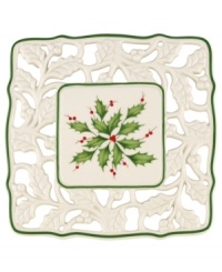 With bands of green, pierced detail and a holly motif to match the beloved Holiday dinnerware pattern, this porcelain trivet from Lenox protects a festive table. With bands of green, pierced detail and a holly motif to match the beloved Holiday dinnerware pattern, this porcelain trivet from Lenox protects a festive table.