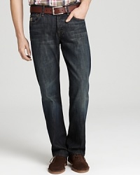 Five pocket jeans have a natural waist and are roomy through the hip and thigh, opening into a bootcut hem. Features 7 for All Mankind's signature squiggle embroidery on back pockets. In a dark wash with slight fading in the thigh and rear. Five pocket jeans have a natural waist and are roomy through the hip and thigh, opening into a bootcut hem. Features 7 for All Mankind's signature squiggle embroidery on back pockets. In a dark wash with slight fading in the thigh and rear.