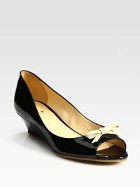 Glossy patent leather staple has a slight wedge, rubber sole and dainty, contrasting bow. Self-covered wedge, 1½ (40mm)Patent leather upperLeather liningRubber solePadded insoleMade in ItalyOUR FIT MODEL RECOMMENDS ordering true size. Glossy patent leather staple has a slight wedge, rubber sole and dainty, contrasting bow. Self-covered wedge, 1½ (40mm)Patent leather upperLeather liningRubber solePadded insoleMade in ItalyOUR FIT MODEL RECOMMENDS ordering true size.
