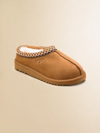 Both a shoe and slipper, this ultra-cozy, ultra-comfy style has slipper-like styling plus a sturdy sole for outdoor wear. Suede upper Sheepskin lining Heritage Tasman braid collar edging Clasic EVA outsole Imported Both a shoe and slipper, this ultra-cozy, ultra-comfy style has slipper-like styling plus a sturdy sole for outdoor wear. Suede upper Sheepskin lining Heritage Tasman braid collar edging Clasic EVA outsole Imported
