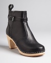Swedish Hasbeens adds a bit of equestrian detail to signature clog booties with buckled ankle details and pull tabs. Lighweight and stylish, they're a comfort-meets-cool choice.