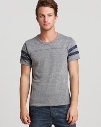 Take a trip back in time with this nostalgic football tee, striped on the sleeves for a touch of vintage inspiration. Take a trip back in time with this nostalgic football tee, striped on the sleeves for a touch of vintage inspiration.
