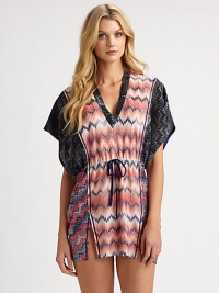 Contrasting patterns flawlessly combine to create this v-neck caftan with a flattering drawstring waist.V-neckKimono sleevesDrawstring waistSide slitsPull-on styleRayon/polyesterHand washMade in Italy of imported fabric Contrasting patterns flawlessly combine to create this v-neck caftan with a flattering drawstring waist.V-neckKimono sleevesDrawstring waistSide slitsPull-on styleRayon/polyesterHand washMade in Italy of imported fabric