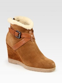 Urban-cool suede and leather essential, lined with shearling and heightened by a comfortable wedge. Suede-covered wedge, 3½ (90mm)Rubber platform, ½ (15mm)Compares to a 3 heel (75mm)Weatherproof suede and leather upper with faux shearling trimBack zip and adjustable leather strapFaux shearling liningSlip resistant rubber solePadded insoleMade in Italy Urban-cool suede and leather essential, lined with shearling and heightened by a comfortable wedge. Suede-covered wedge, 3½ (90mm)Rubber platform, ½ (15mm)Compares to a 3 heel (75mm)Weatherproof suede and leather upper with faux shearling trimBack zip and adjustable leather strapFaux shearling liningSlip resistant rubber solePadded insoleMade in Italy