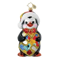 A cute penguin in a colorful santa hat and bow tie holds a multi-colored puzzle piece, the symbol for Autism Awareness. A cute penguin in a colorful santa hat and bow tie holds a multi-colored puzzle piece, the symbol for Autism Awareness.