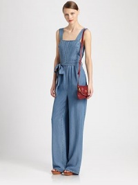 Fashion-forward denim jumpsuit has a pintucked bodice, darling self tie at the waist and wide-leg construction. SquareneckWide strapsSelf tie at the waistSlash pocketsBack zipperAbout 62 from shoulder to hemLyocellDry cleanImportedModel shown is 5'10 (177cm) wearing US size Small. Fashion-forward denim jumpsuit has a pintucked bodice, darling self tie at the waist and wide-leg construction. SquareneckWide strapsSelf tie at the waistSlash pocketsBack zipperAbout 62 from shoulder to hemLyocellDry cleanImportedModel shown is 5'10 (177cm) wearing US size Small.