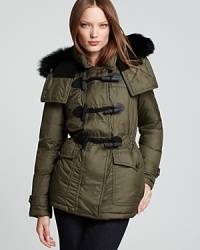 Utilitarian-style pockets and statement toggle closures lend military inspiration to a Burberry Brit down jacket, finished with a luxe fur-trimmed hood and a flattering cinched waist for the ultimate in cold-weather chic. Utilitarian-style pockets and statement toggle closures lend military inspiration to a Burberry Brit down jacket, finished with a luxe fur-trimmed hood and a flattering cinched waist for the ultimate in cold-weather chic.