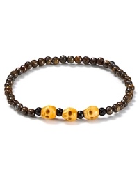 Beaded bronzite sets the stage for 3 skulls carved from antique bone on this statement bracelet from Chan Luu. Beaded bronzite sets the stage for 3 skulls carved from antique bone on this statement bracelet from Chan Luu.