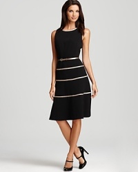 A swing skirt lends a ladylike look to this belted Anne Klein dress, trimmed in metallic stripes. A swing skirt lends a ladylike look to this belted Anne Klein dress, trimmed in metallic stripes.