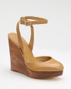 A richly stained wood wedge and platform sit underneath a leather sandal with a shapely closed toe and slender ankle strap.Wood wedge, 5½ (140mm) Wood platform, 1 (25mm) Compares to a 4½ heel (115mm) Buckle ankle strap Leather lining and sole Padded insole ImportedOUR FIT MODEL RECOMMENDS ordering one half size up as this style runs small. 