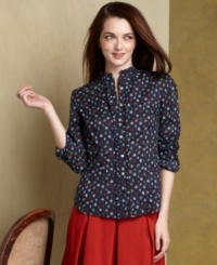 Strike a feminine note in Tommy Hilfiger's floral-printed button-down shirt, complete with crisp ruffled trim at the collar and placket. Strike a feminine note in Tommy Hilfiger's floral-printed button-down shirt, complete with crisp ruffled trim at the collar and placket.