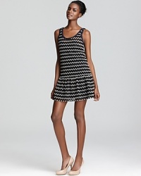 A sprinkling of sequins lend ever-so-subtle sparkle to this Ali Ro knit dress, finished with a feminine ruffle skirt. A sprinkling of sequins lend ever-so-subtle sparkle to this Ali Ro knit dress, finished with a feminine ruffle skirt.