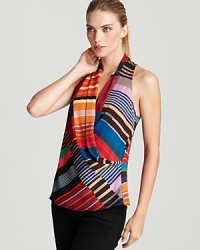 Bright multi-colored stripes add a colorful dimension to this striking Trina turk top--a criss-cross front lends an alluring look and shape to this sleeveless standout. Bright multi-colored stripes add a colorful dimension to this striking Trina turk top--a criss-cross front lends an alluring look and shape to this sleeveless standout.