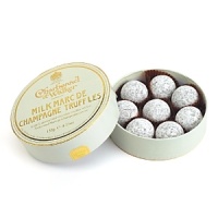 Lightly dusted truffles with a milk chocolate butter and Marc de Champagne center. Lightly dusted truffles with a milk chocolate butter and Marc de Champagne center.