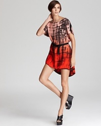 A dramatic high/low silhouette lends a cool, modern edge to this Patterson J. Kincaid dress, imbued with a color-soaked tie-dye print. A dramatic high/low silhouette lends a cool, modern edge to this Patterson J. Kincaid dress, imbued with a color-soaked tie-dye print.