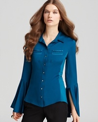 Detailed pockets and flared sleeves lend a retro feel to this Elie Tahari blouse, crafted in stretch silk. Detailed pockets and flared sleeves lend a retro feel to this Elie Tahari blouse, crafted in stretch silk.