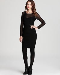 A crisscross bodice is detailed with dramatic ribbing on this Elie Tahari dress, rendered with an elusive sheer yoke. A crisscross bodice is detailed with dramatic ribbing on this Elie Tahari dress, rendered with an elusive sheer yoke.