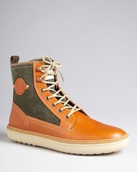 These cool boots from Fred Perry give your casual look a little more polish and your sharper attire a bit of sporty flair. Crafted in leather and canvas for a striking contrast. These cool boots from Fred Perry give your casual look a little more polish and your sharper attire a bit of sporty flair. Crafted in leather and canvas for a striking contrast.