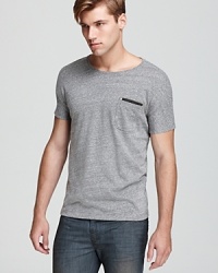 Subtle moire stripes and an applique strip at the chest pocket imbue this timeless gray tee with thoughtfully handsome details. Subtle moire stripes and an applique strip at the chest pocket imbue this timeless gray tee with thoughtfully handsome details.