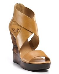 Chic strappy leather sandals with a sculptural wedge for a modern touch. Chic strappy leather sandals with a sculptural wedge for a modern touch.