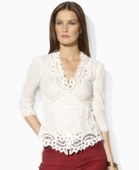 Steeped in vintage inspiration, Lauren Jeans Co.'s delicate wrap top is rendered in woven cotton and accented with lace detailing along the neckline, cuffs and hem. Steeped in vintage inspiration, Lauren Jeans Co.'s delicate wrap top is rendered in woven cotton and accented with lace detailing along the neckline, cuffs and hem.