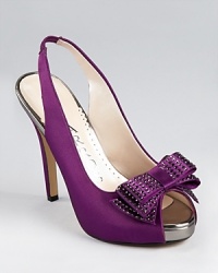 Sumptuous satin is studded in sparkling rhinestones on Caparros' sleek Betsey Bow slingbacks. Metallic lining peeks out at the peep toe. Sumptuous satin is studded in sparkling rhinestones on Caparros' sleek Betsey Bow slingbacks. Metallic lining peeks out at the peep toe.