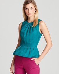 A jewel-colored Trina Turk top featuring a classic peplum waist for ladylike charm, rendered in luxurious woven silk. A jewel-colored Trina Turk top featuring a classic peplum waist for ladylike charm, rendered in luxurious woven silk.