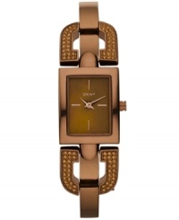 DKNY takes a unique turn with this darling sparkling bangle watch. Crafted of brown ion-plated stainless steel half-bangle bracelet with crystal-accented D-shaped links at rectangular case. Brown dial features rose-gold tone stick indices at three, six, nine and twelve o'clock, two hands and logo at twelve o'clock. Quartz movement. Water resistant to 50 meters. Two-year limited warranty. DKNY takes a unique turn with this darling sparkling bangle watch. Crafted of brown ion-plated stainless steel half-bangle bracelet with crystal-accented D-shaped links at rectangular case. Brown dial features rose-gold tone stick indices at three, six, nine and twelve o'clock, two hands and logo at twelve o'clock. Quartz movement. Water resistant to 50 meters. Two-year limited warranty.