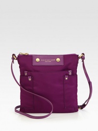 A lightweight casual staple in durable nylon with sleek leather accents and convenient front pockets. Adjustable leather shoulder strap, 19½-22½ dropTop zip closureThree outside open pocketsOne inside zip pocketTwo inside open pocketsFully lined9½W X 10H X ½DImported A lightweight casual staple in durable nylon with sleek leather accents and convenient front pockets. Adjustable leather shoulder strap, 19½-22½ dropTop zip closureThree outside open pocketsOne inside zip pocketTwo inside open pocketsFully lined9½W X 10H X ½DImported