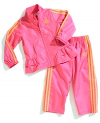 Ruffles and vibrant colors add girlie appeal to this sporty windbreaker jacket and pant set from adidas. Ruffles and vibrant colors add girlie appeal to this sporty windbreaker jacket and pant set from adidas.