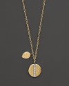 Gold medallion necklace with diamond accents, paired with an additional gold charm. Designed by Meira T.