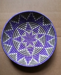 Revive a room and a community. Hand-woven in a pattern inspired by African gemstones, this vibrant basket incorporates cool gray and bold violet tones to bring attention to Rwanda Path to Peace, an organization that supports women artisans. Revive a room and a community. Hand-woven in a pattern inspired by African gemstones, this vibrant basket incorporates cool gray and bold violet tones to bring attention to Rwanda Path to Peace, an organization that supports women artisans.