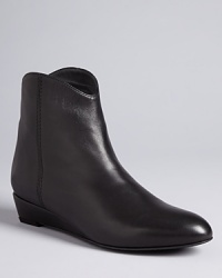 Stuart Weitzman delivers a subtle dose of Western style with these low-key booties, with aerodynamic lines set on streamlined wedge heels. Stuart Weitzman delivers a subtle dose of Western style with these low-key booties, with aerodynamic lines set on streamlined wedge heels.