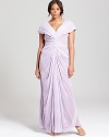 Touting exquisite ruching and draping, this Tadashi Shoji Plus gown is punctuated by a sparkling embellishment at the bodice for extra glamour.