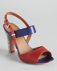 A snake embossed heel offers a flashy finish on Elie Tahari's Eva sandals, a color block silhouette showcasing bright, vibrant hues. A snake embossed heel offers a flashy finish on Elie Tahari's Eva sandals, a color block silhouette showcasing bright, vibrant hues.