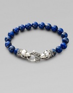 A welcome touch of color, strung with 10mm lapis beads and a raven's head sterling silver clasp.About 9¼ long Imported