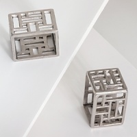 Dozens of square and rectangular cutouts give this napkin ring set from Natori a modern, dimensional look. Dozens of square and rectangular cutouts give this napkin ring set from Natori a modern, dimensional look.