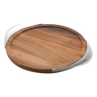 With its smooth curves and striking blend of materials, the Tilt Bar Tray has an almost planetary mood to it, a fitting complement to the canted axis of Tilt crystal. Fashioned with an acacia wood center and framed by tapered grips of gleaming Nambé alloy, the tray is a beautiful way to bring fresh cocktails to your friends or pass champagne at a celebration. The raised flat rim contains drips or errant ice cubes, and the contoured handles fit the palm and thumb with ease. The rich grain of the wood complements the high luster of the metal, and the overall combination is modern yet enduring. Designed by Todd Myers, the tray is an excellent gift for connoisseurs of bar-keeping elegance. With its smooth curves and striking blend of materials, the Tilt Bar Tray has an almost planetary mood to it, a fitting complement to the canted axis of Tilt crystal. Fashioned with an acacia wood center and framed by tapered grips of gleaming Nambé alloy, the tray is a beautiful way to bring fresh cocktails to your friends or pass champagne at a celebration. The raised flat rim contains drips or errant ice cubes, and the contoured handles fit the palm and thumb with ease. The rich grain of the wood complements the high luster of the metal, and the overall combination is modern yet enduring. Designed by Todd Myers, the tray is an excellent gift for connoisseurs of bar-keeping elegance.