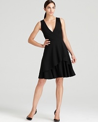 Carry off the ladylike trend in this DKNY dress flaunting a wrap bodice and ruffled skirt for effortless elegance. Polish off the style with heels and a dash of pearls. Carry off the ladylike trend in this DKNY dress flaunting a wrap bodice and ruffled skirt for effortless elegance. Polish off the style with heels and a dash of pearls.