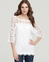 Brimming with boho charm, this XCVI tunic flaunts delicate crochet sleeves for a ladylike finish.